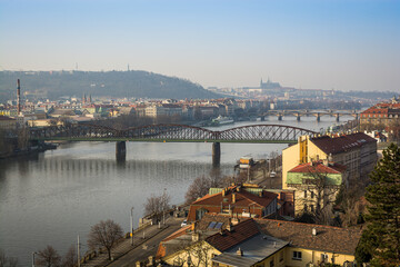 Naklejka premium Panorama of Prague with Prague Castle and Railway Bridge in haze in Winter