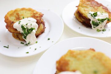 Potato pancakes with sour cream and herbs