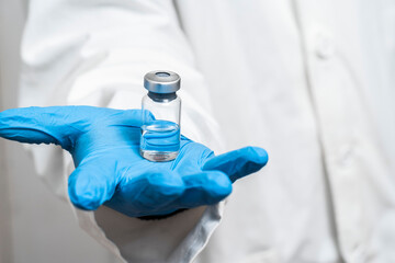 Doctor holding medicine for vaccination, closeup