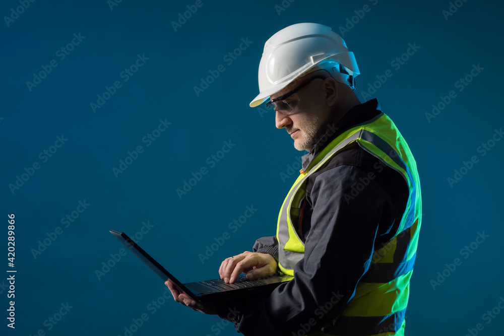 Aufkleber worker in a white safety helmet. worker with a laptop in his hands. concept - worker engineer on a d