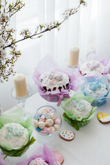 Beautiful Easter cakes on a decorated light table. A light holiday of Easter.
