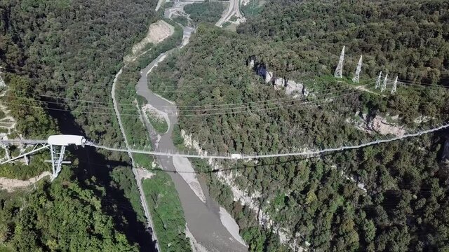 Flight around longest suspension footbridge across the canyon river. Sochi, Skypark. 