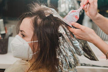The work of hairdressers during the world quarantine, the process of applying hair dye.
