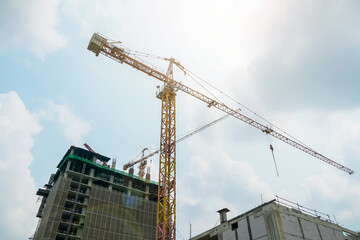 Construction crane on the background of the sky. Construction site.Use as illustration for presentation.  
