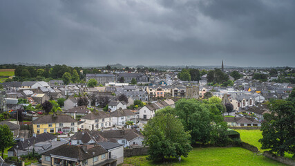 Fototapeta na wymiar Panoramic view on Cashel town, cityscape from Rock of Cashel castle hill with dramatic storm sky in background, Tipperary, Ireland