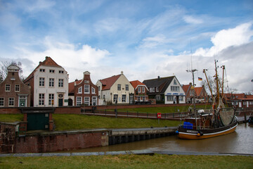 The view of the old traditional houses in the harbor of Greetsiel