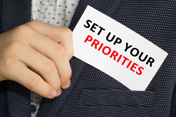 Card with text SET UP YOUR PRIORITES on hand. You can use in business, marketing and other...