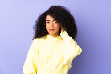 Young african american woman isolated on purple background having doubts