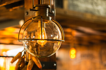 old wooden pole light lit up at night