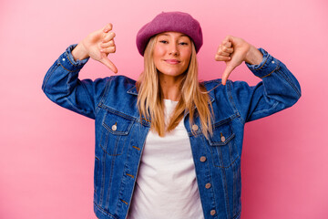 Young mixed race woman isolated on pink background feels proud and self confident, example to follow.