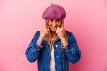 Young mixed race woman isolated on pink background upset screaming with tense hands.