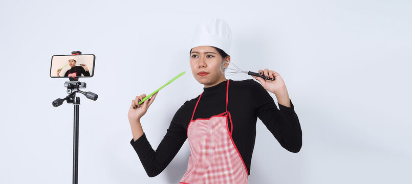 Food blogger streaming live. Online food instructor woman chef. Cooking with subscribers through phone camera online. vlogger and online influencer recording video content on healthy food. 