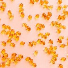 Omega three capsules on beige background flat lay. Health concept. Vitamin pills