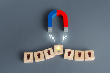 A magnet attracts a glowing idea light bulb. Choosing fresh idea. Business accelerator. Innovation....
