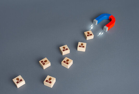 The magnet attracts new employees. Attracting the attention of investors. Hiring highly qualified professional staff. Business team building. Human resources. Recruiting staffing. Advertising concept