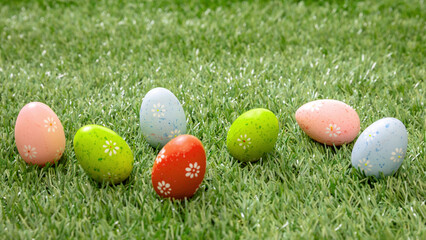 Happy Easter. Colorful eggs on green grass, close up view