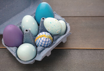 Happy Easter. Blue pastel color eggs variety on blue wooden background