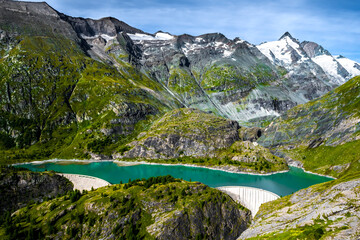 Fototapeta na wymiar Pasterze Glacier Lake With Hydropower Dam In National Park Hohe Tauern With Großglockner High Alpine Road In Austria
