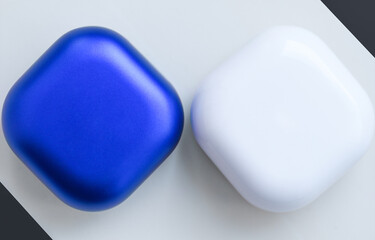 Two colored cases for wireless headphones on a white background