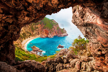 Beautiful magical view of the Gyali beach in Corfu, Greece through a hole in the rock. amazing places. popular tourist atraction.