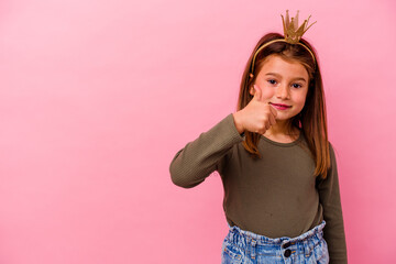 Little princess girl with crown isolated on pink background smiling and raising thumb up © Asier