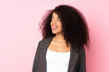 Young african american woman over isolated background looking to the side and smiling