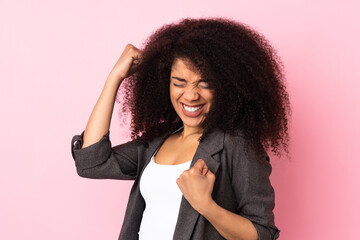 Young african american woman over isolated background celebrating a victory