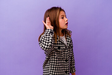 Little caucasian girl isolated on purple background Little caucasian girl isolated on purple background trying to listening a gossip.