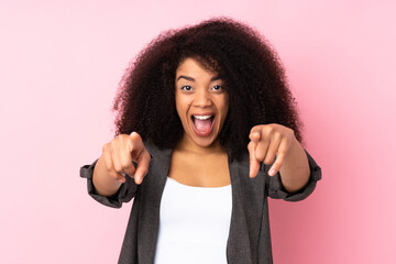 Young african american woman over isolated background surprised and pointing front