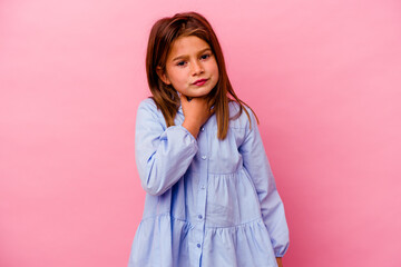 Little caucasian girl isolated on pink background  suffers pain in throat due a virus or infection.