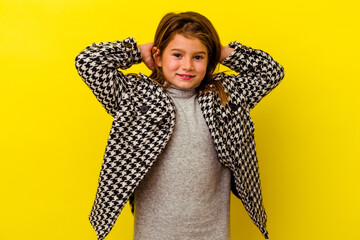 Little caucasian girl isolated on yellow background feeling confident, with hands behind the head.