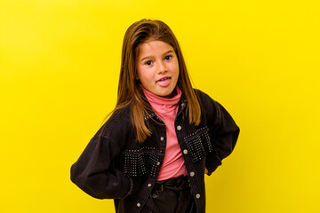 Little caucasian girl isolated on yellow background funny and friendly sticking out tongue.