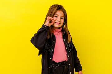 Little caucasian girl isolated on yellow background cheerful and confident showing ok gesture.