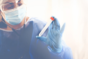 female doctor examines a test tube with tests. Medical concept. Blood tests and tests during the...