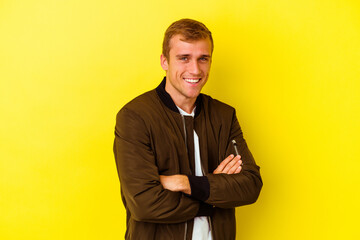 Young caucasian man isolated on yellow background