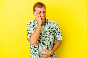 Young caucasian man isolated on yellow background
