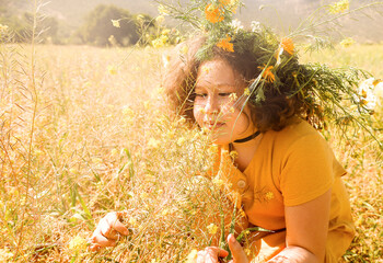 Girl with wreath on head in the field.