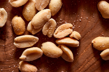 Salted peanuts on a wooden background. With copy space.Macro effect photo. Macro effect photo.
