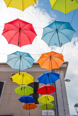 Two rows of colourful umbrellas on the sky