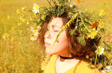 Girl in a wreath of flowers.