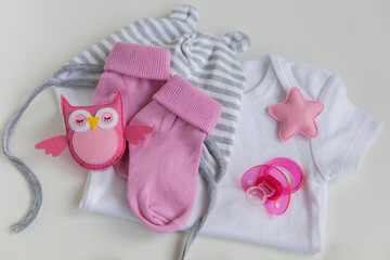 infant baby clothes baby girl pacifier cap on background