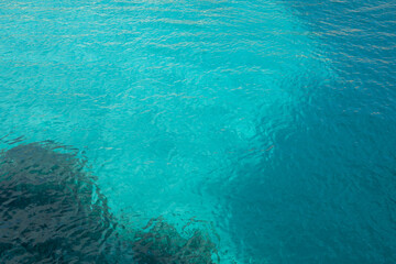 Fototapeta na wymiar Clear turquoise waters of the Mediterranean sea in a cala of Minorca, in Balearic Islands, Spain