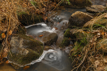 Small creek with waterfall near Vltava river in valley north from Hluboka town