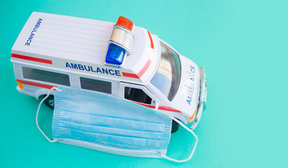 close up of the toy ambulance car on blue background..