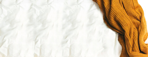 Bedding with mustard warm plaid. Copy space. Flat lay, top view