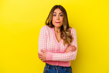 Young caucasian woman isolated on yellow background