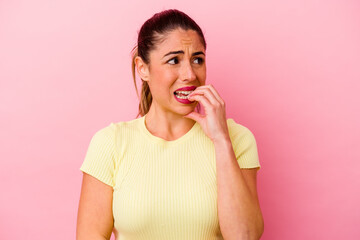 Young caucasian woman isolated on pink background