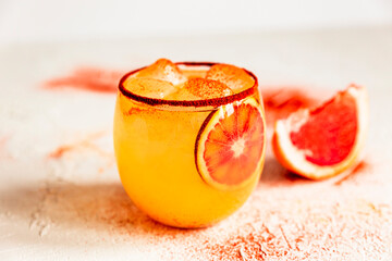 Blood orange margarita cocktail in an old fashioned glass with smoked paprika on the rim, pink grapefruit. High key light and bright horizontal photo. - 420306864