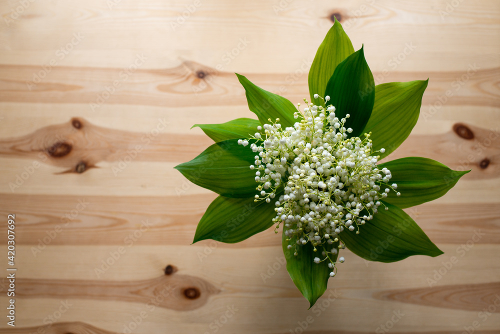 Sticker Top-down shot of beautiful bouquet of lily of the valley on old wooden table. Photo with copy space