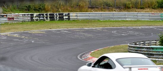 White sports car going fast on the race track